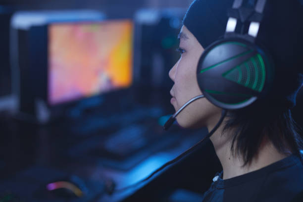 istock Asian Gamer Wearing Headset 1203972768