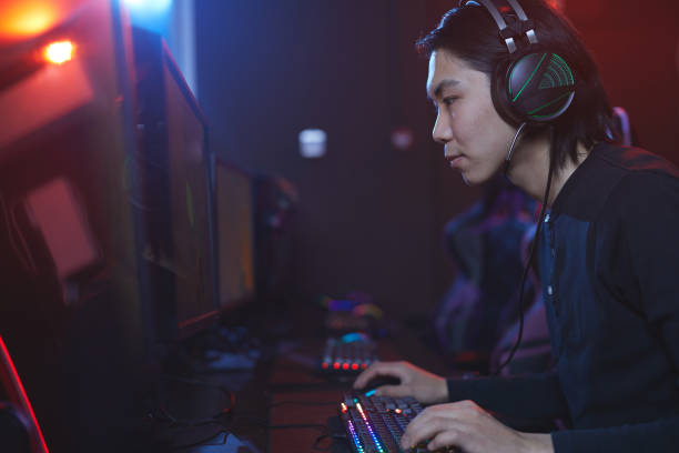 istock Asian Man Playing Videogame 1203972773