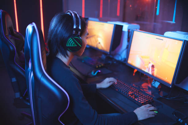 istock Young Man Gaming in Computer Club 1203972920