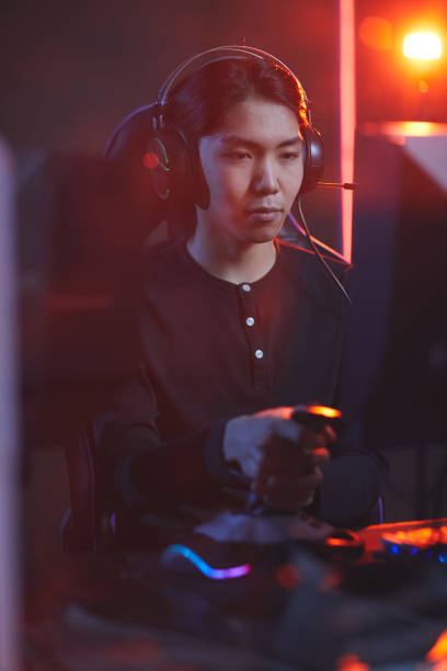 istock Asian Young Man in Gaming Club 1203972926