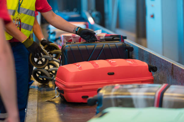 istock Airport service crew unloading luggage 1203972928