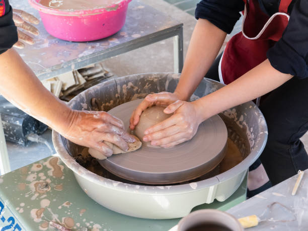 istock potter's hands shaping soft clay to make an earthen pot 1203973085