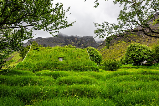 Hof, Iceland church, the last build in traditional turf style, Hofskirkja building roof covered in green grass with window