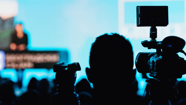 istock Camera Recording Presentation Of A Speaker 1203973486