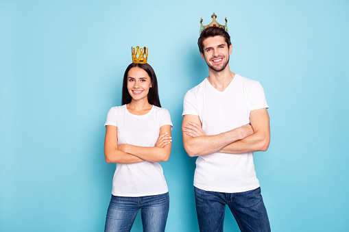 Portrait of his he her she nice attractive lovely charming cheerful cheery, content couple wearing tiara folded arms isolated on bright vivid shine vibrant blue green turquoise background