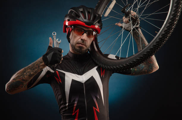 istock guy-cyclist in a Bicycle helmet with a Bicycle wheel 1203975039