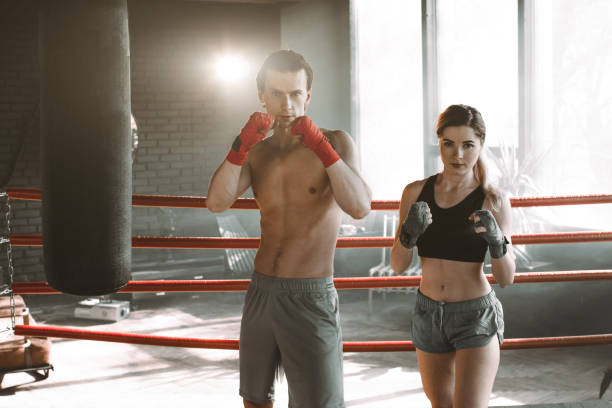 istock Woman on boxing training with personal trainer 1203975658