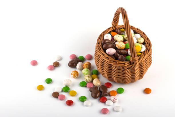 istock Easter basket with colored candies on a white background with a copy of the space 1203976917