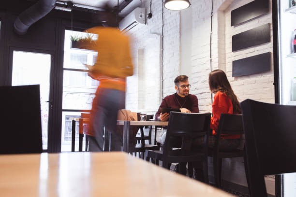 istock Waiter Takes Order From a young Couple 1203976997