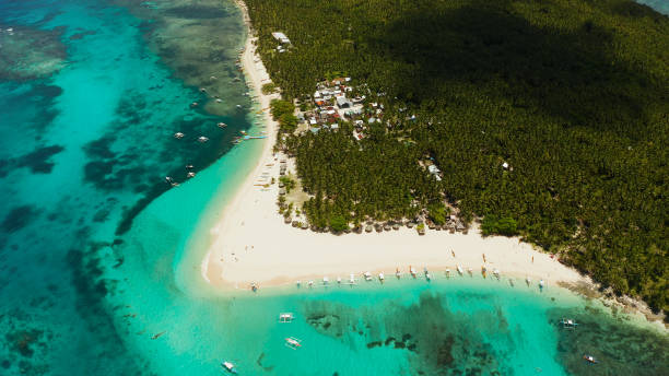istock Tropical Daco Island with a sandy beach and tourists 1203978849