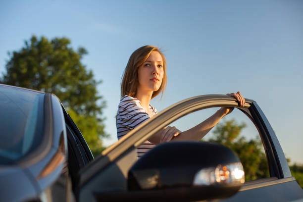 istock Pretty, young woman driving her car 1203979531