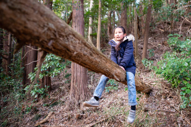 istock Girl playing in the forest 1203980677