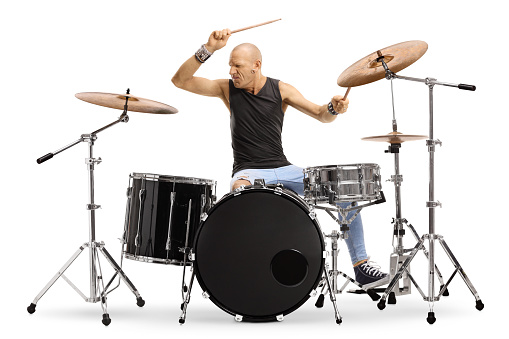 Bald man musician playing drums isolated on white background