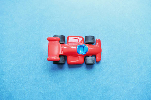 istock plastic racing car on wooden table 1203982623