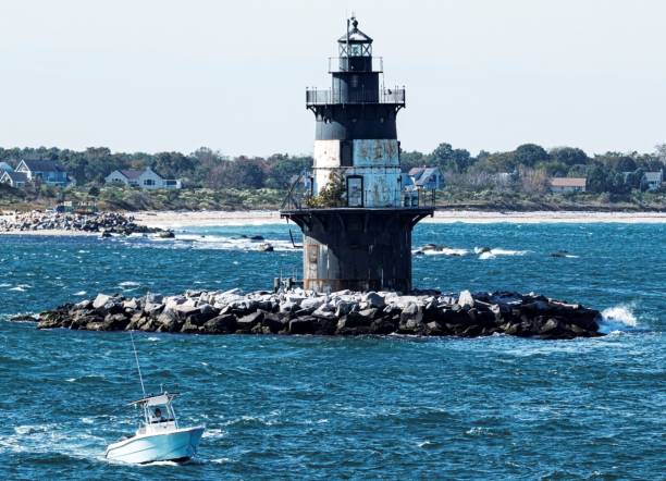 istock Small motor boat passing the Orient Lighthouse 1203982636