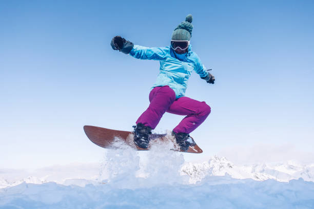 istock Happy female snowboarder 1203984217