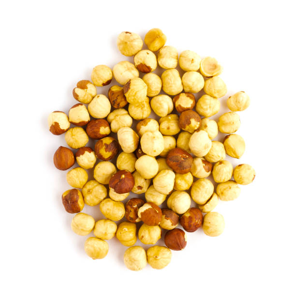 istock Heap of roasted hazelnut isolated on white background 1203986682