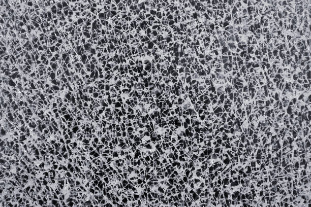 istock Abstract white pattern of a cracked glass pane 1203986818