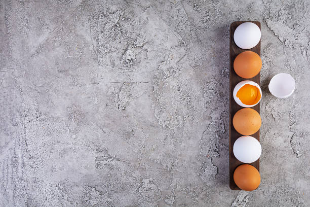 istock Colorful chicken eggs. Fresh chicken eggs on wooden background. Top view 1203987385