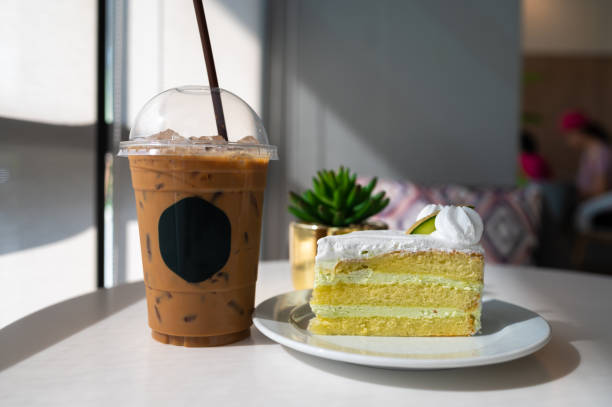 Iced coffee with melon cake on white table in restaurant