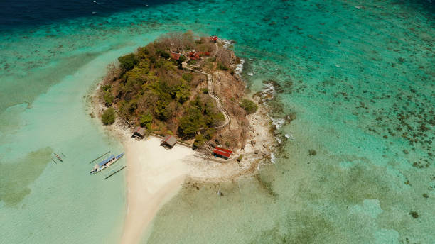 istock Small torpic island with a white sandy beach, top view 1203987479