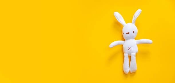 Toys for newborns on a yellow background. Selective focus.