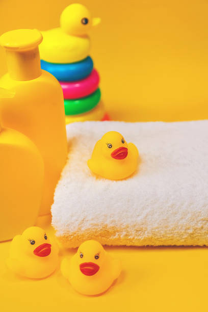 istock Accessories for bathing newborns on a yellow background. Selective focus. 1203988671