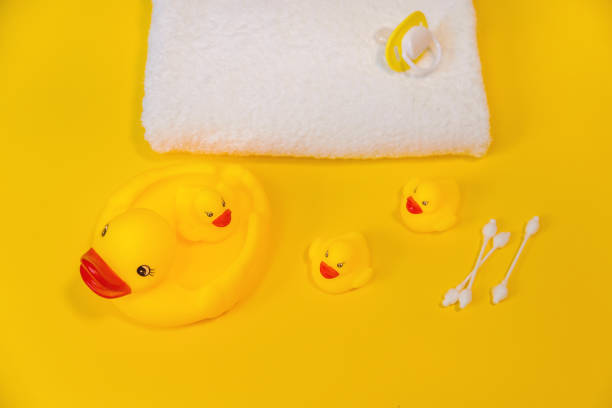 istock Accessories for bathing newborns on a yellow background. Selective focus. 1203988713