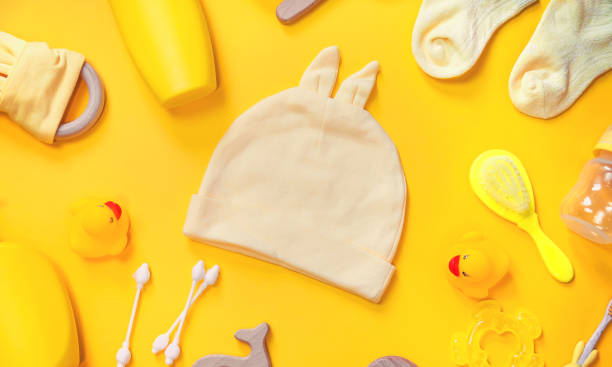 istock Accessories for newborns on a yellow background. Selective focus. 1203988789