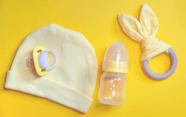 Accessories for newborns on a yellow background. Selective focus.