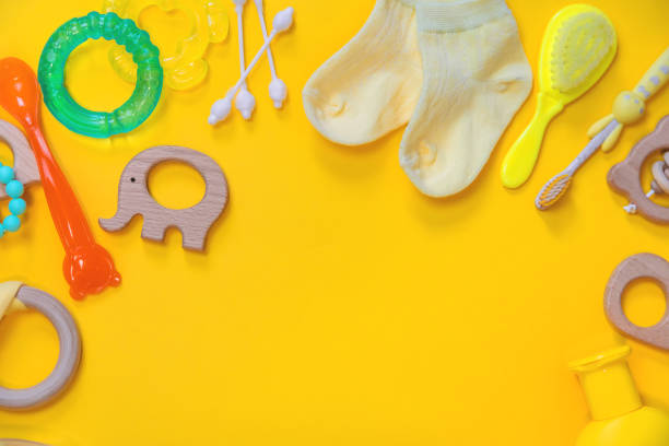 istock Accessories for newborns on a yellow background. Selective focus. 1203988851