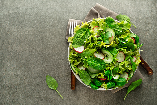 Healthy Green salad with fresh vegetables on grey table background