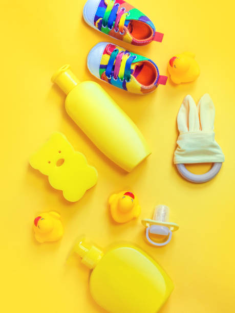 istock Accessories for bathing newborns on a yellow background. Selective focus. 1203989404