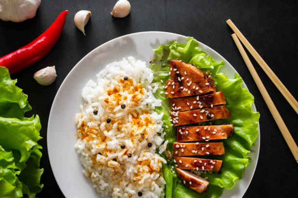 istock Teriyaki chicken with white rice on a plate. 1203990905