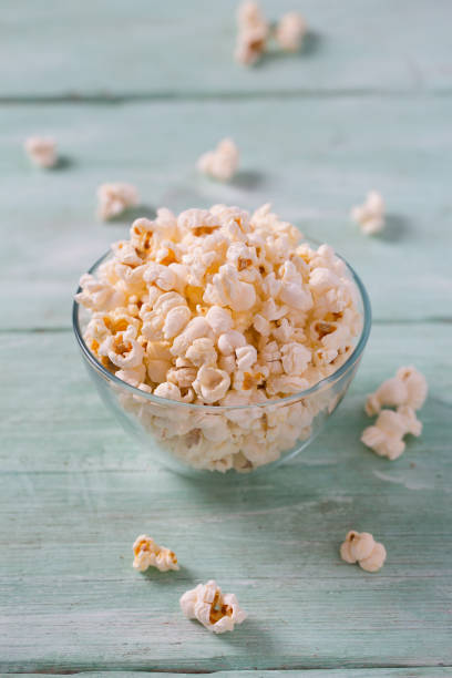 istock salty popcorn on turquoise wooden surface 1203990926