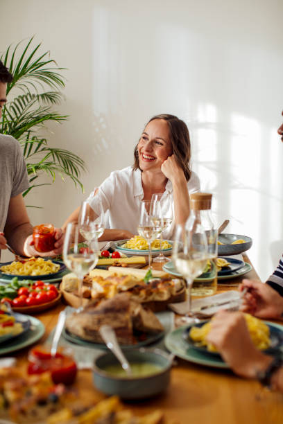 istock A Woman Enjoying Dinner with Friends 1203991600