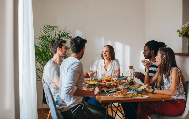 istock Young People Having Lunch at Home 1203991613