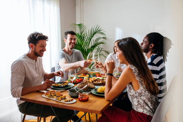 istock Friends Celebrating and Rising Wine Glasses 1203991656
