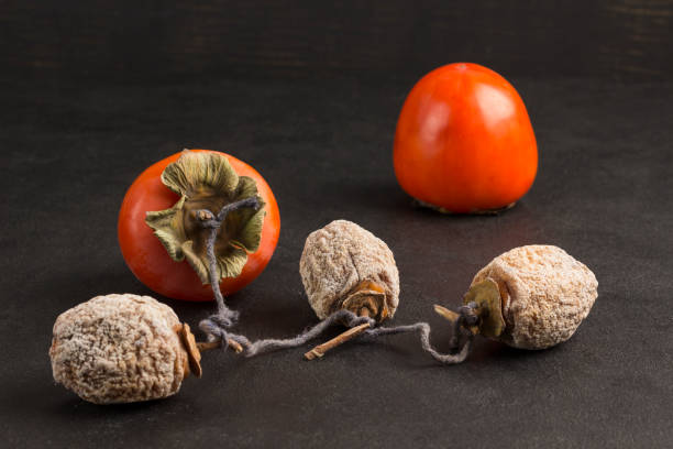 istock Fresh persimmons and dried persimmons 1203992474