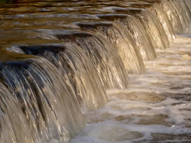 water flowing over a small weir