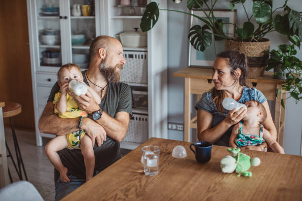 time to feed baby's - love growth time of day cheerful imagens e fotografias de stock