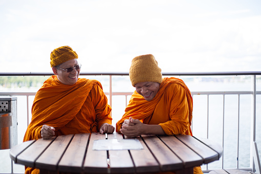 Two modern monks enjoying a ship ride while bonding and talking
