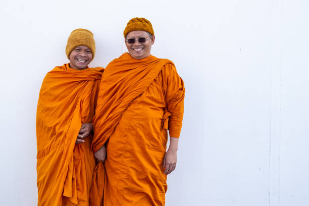 Portrait two modern monks wearing orange ceremonial robes