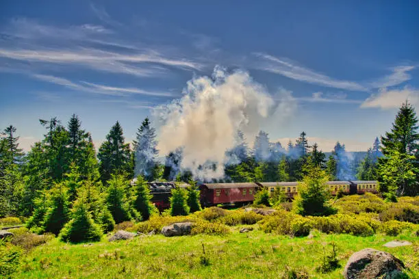 Looking at the Brocken Railway (German: Brockenbahn) who is very popular because they use historic steam trains on the Brocken Railway and have become very popular with thousands of tourists every year, offering convenient access to the top of the Brocken. The Brocken also sometimes referred to as the Blocksberg, is the highest peak of the Harz mountain range with 1,141 meters high. The Brocken has always played a role in legends and has been connected with witches and devils; Johann Wolfgang von Goethe took up the legends in his play Faust.