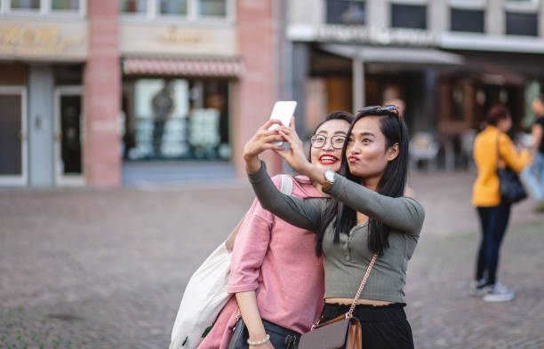 istock Joyful female tourists marking their visit with a selfie 1203996712