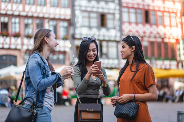 istock Multi-ethnic group of female tourists exploring a new town 1203996793
