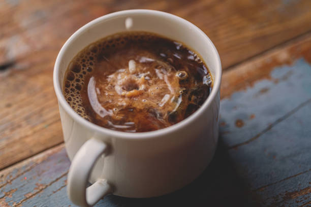 istock Milk Drip Into Coffee On Wood Board 1203997000