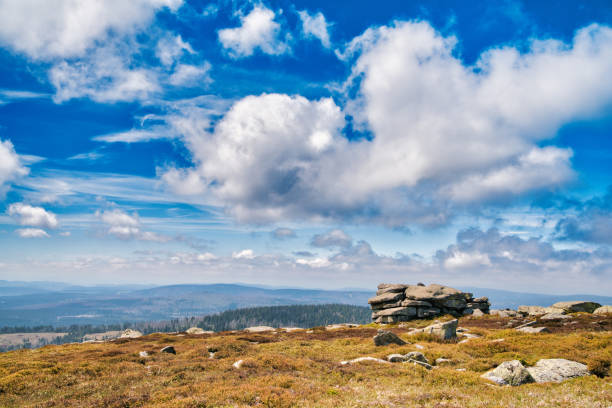Panoramic view from the Brocken over the Harz National Park in Germany. The Brocken also sometimes referred to as the Blocksberg, is the highest peak of the Harz mountain range with 1,141 meters high. The Brocken has always played a role in legends and has been connected with witches and devils; Johann Wolfgang von Goethe took up the legends in his play Faust.