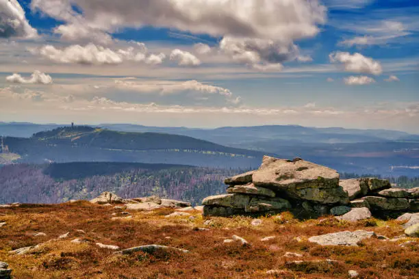 Panoramic view from the Brocken over the Harz National Park in Germany. The Brocken also sometimes referred to as the Blocksberg, is the highest peak of the Harz mountain range with 1,141 meters high. The Brocken has always played a role in legends and has been connected with witches and devils; Johann Wolfgang von Goethe took up the legends in his play Faust.