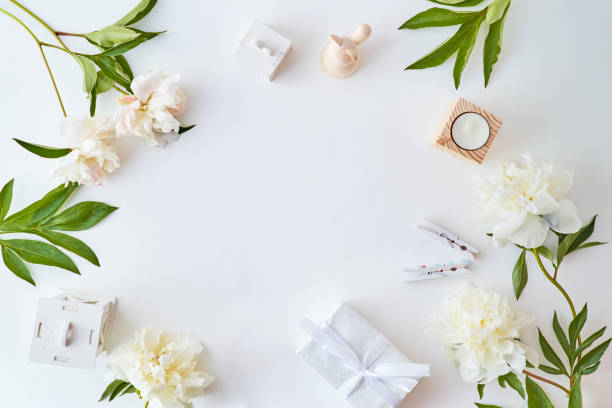 istock Flat lay blogger or freelancer workspace with white peonies on a white table 1203997312